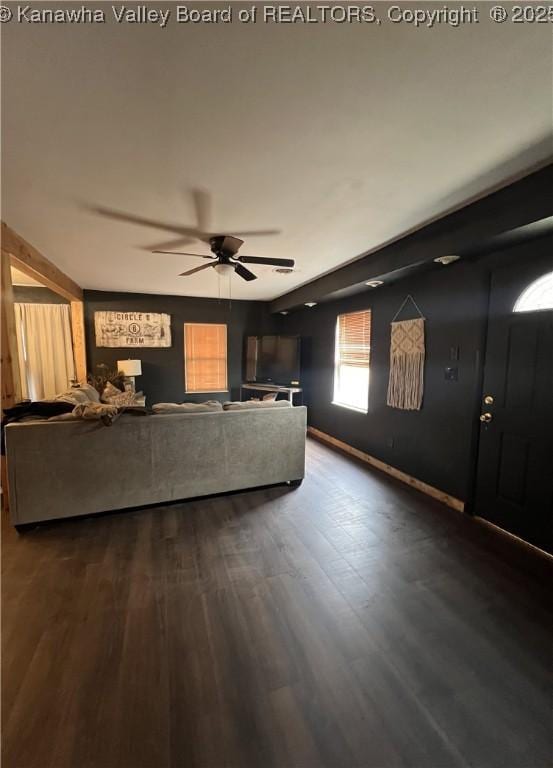 unfurnished living room featuring wood-type flooring and ceiling fan