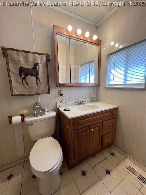 bathroom featuring vanity, tile patterned floors, crown molding, and toilet