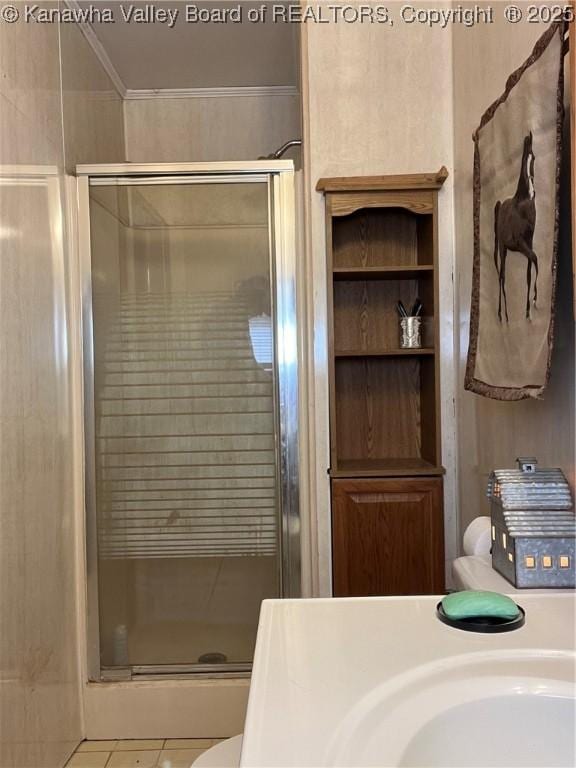 bathroom with sink, ornamental molding, tile patterned floors, and walk in shower