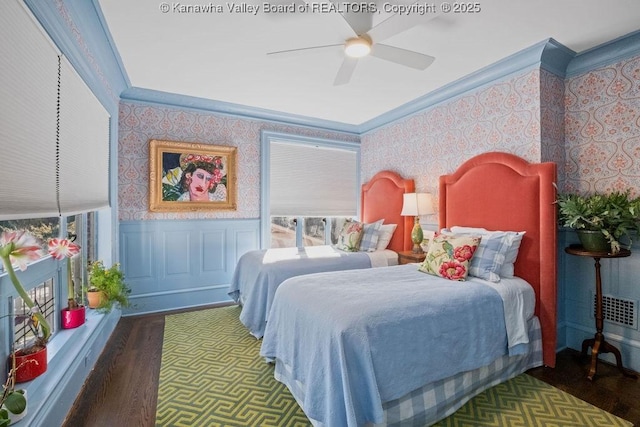 bedroom featuring ceiling fan, ornamental molding, and dark hardwood / wood-style flooring