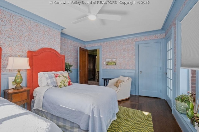 bedroom featuring dark hardwood / wood-style flooring, ornamental molding, and ceiling fan