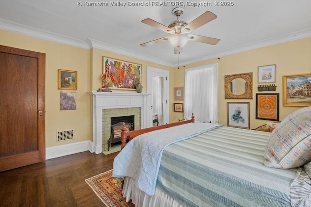 bedroom with ceiling fan, ornamental molding, a fireplace, and dark parquet floors