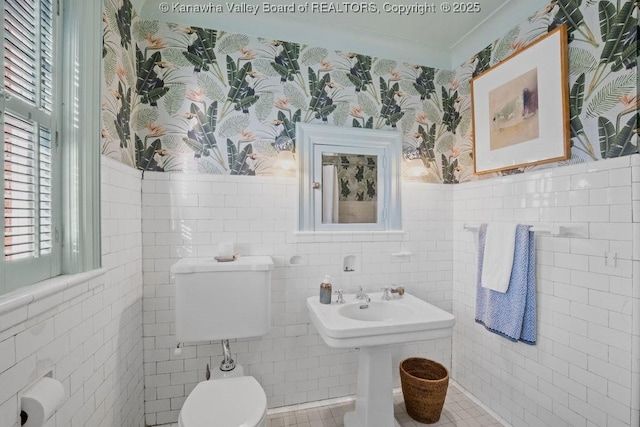 bathroom with ornamental molding, tile walls, and toilet