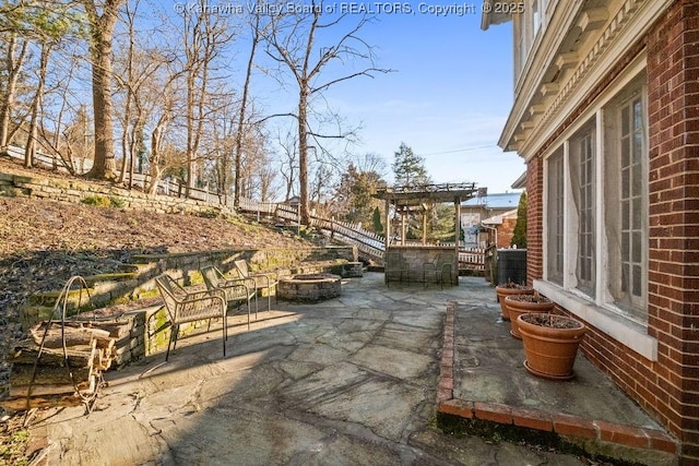 view of patio featuring an outdoor fire pit