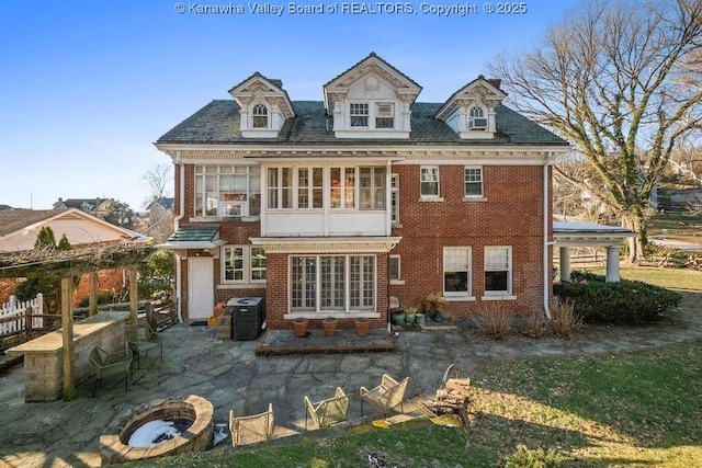 rear view of property featuring a patio and a sunroom