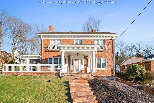 greek revival inspired property featuring a front yard