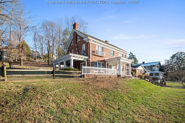 rear view of property with a yard