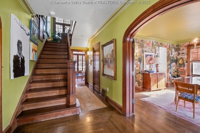 stairway with crown molding and hardwood / wood-style flooring