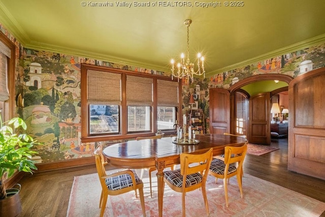 dining room featuring crown molding, a chandelier, and hardwood / wood-style flooring