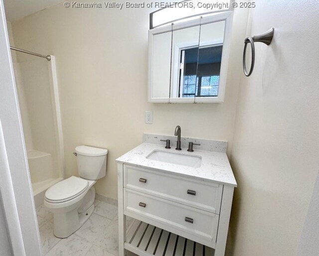 bathroom featuring vanity, toilet, and a shower