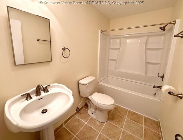 full bathroom featuring tile patterned flooring, bathtub / shower combination, sink, and toilet