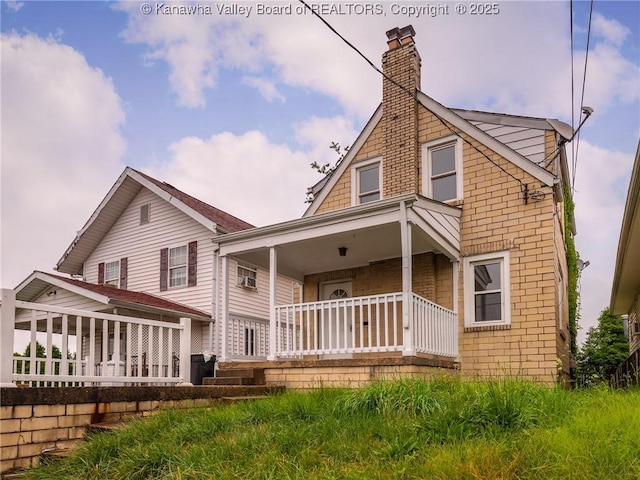 back of property with covered porch