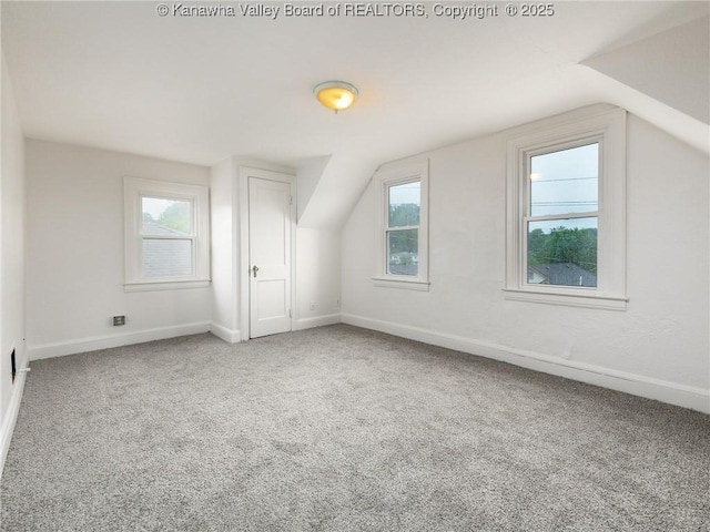 bonus room featuring lofted ceiling and carpet flooring