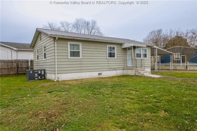 exterior space featuring a yard and central AC unit