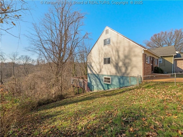 view of side of home with a yard