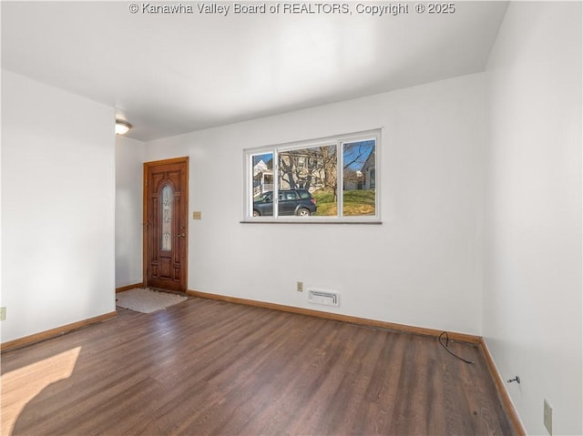 spare room featuring dark hardwood / wood-style floors