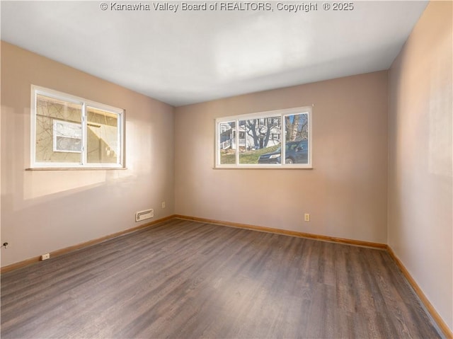 unfurnished room featuring dark wood-type flooring