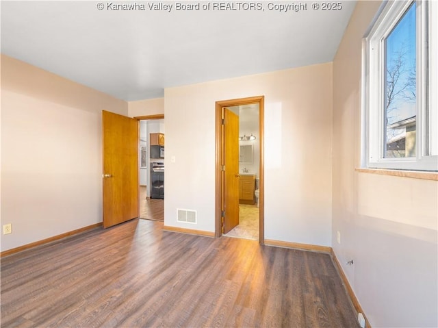 spare room with hardwood / wood-style floors