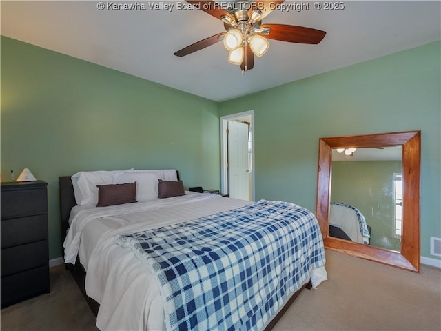 bedroom featuring ceiling fan and carpet