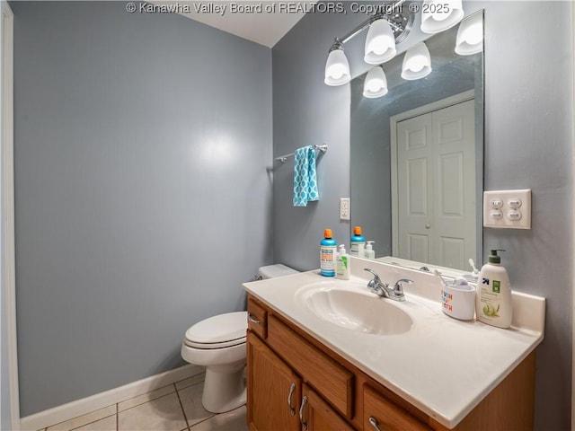 bathroom featuring vanity, tile patterned floors, and toilet