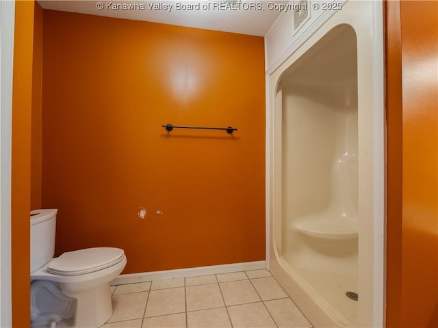 bathroom with walk in shower, tile patterned floors, and toilet