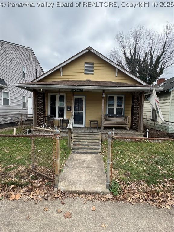 view of front of home with a porch and a front yard