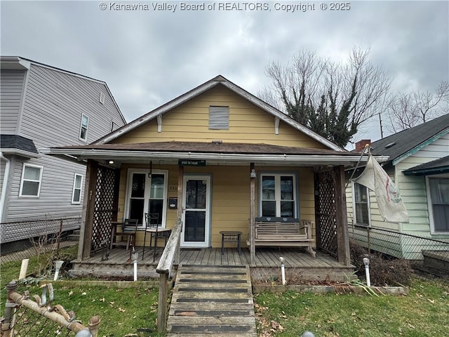 bungalow with a porch and a front yard