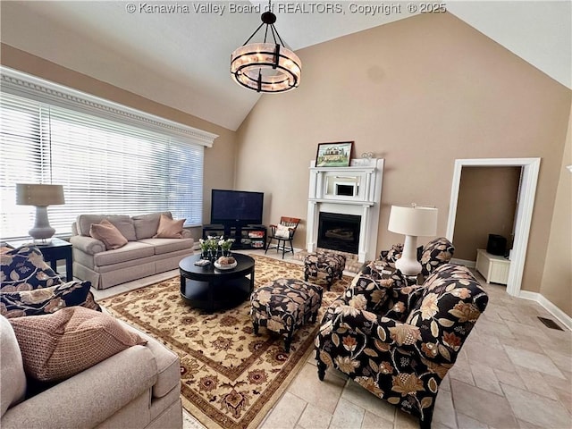 living room featuring high vaulted ceiling