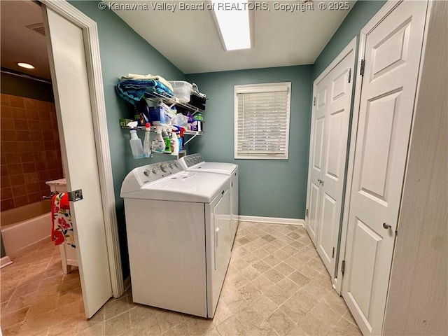 clothes washing area featuring washer and clothes dryer