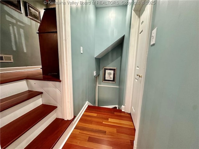 stairway featuring wood-type flooring