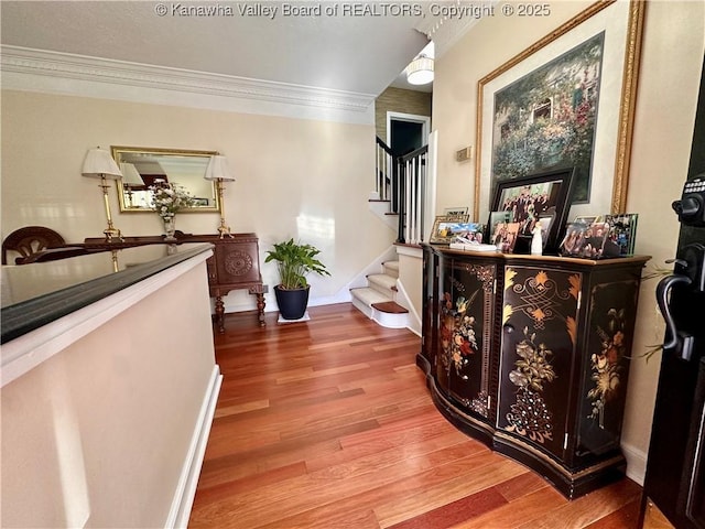 hall featuring hardwood / wood-style flooring and crown molding