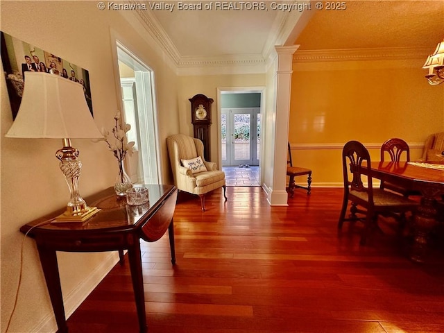 sitting room with ornamental molding, wood-type flooring, and decorative columns