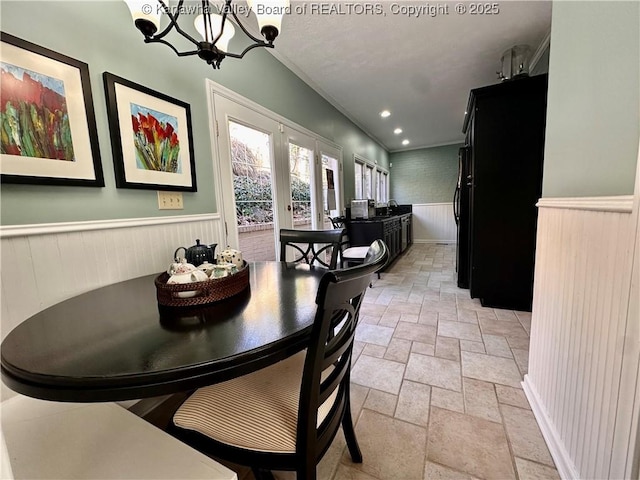 dining room with an inviting chandelier and french doors