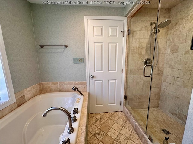 bathroom featuring separate shower and tub