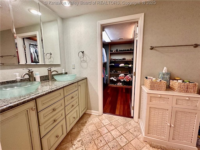 bathroom with vanity and a textured ceiling