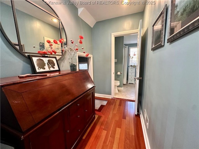 hallway with hardwood / wood-style floors