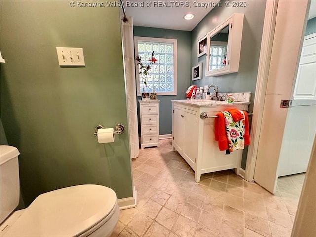 bathroom featuring vanity and toilet