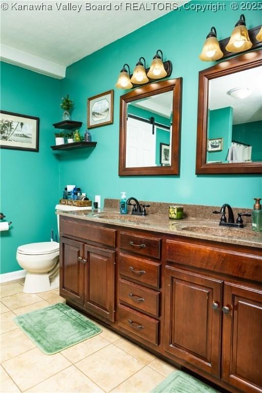 bathroom featuring vanity, tile patterned floors, and toilet