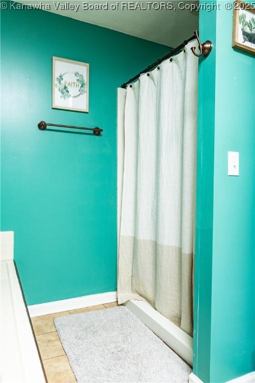 bathroom featuring tile patterned floors and a shower with shower curtain