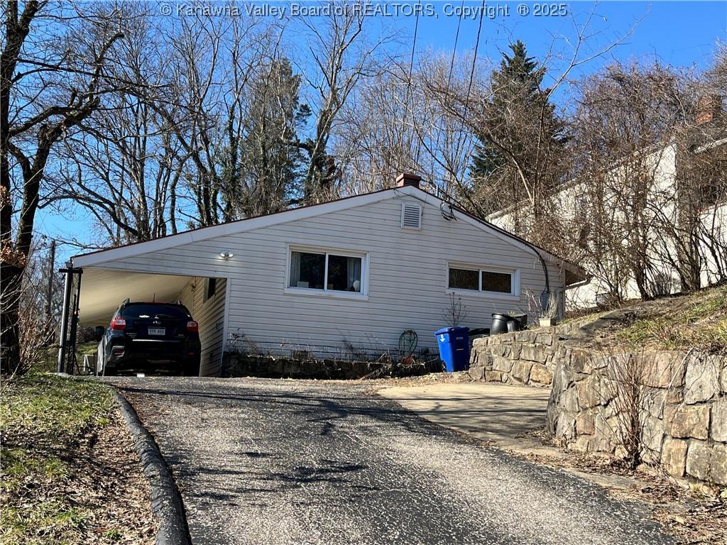 view of side of property with a carport