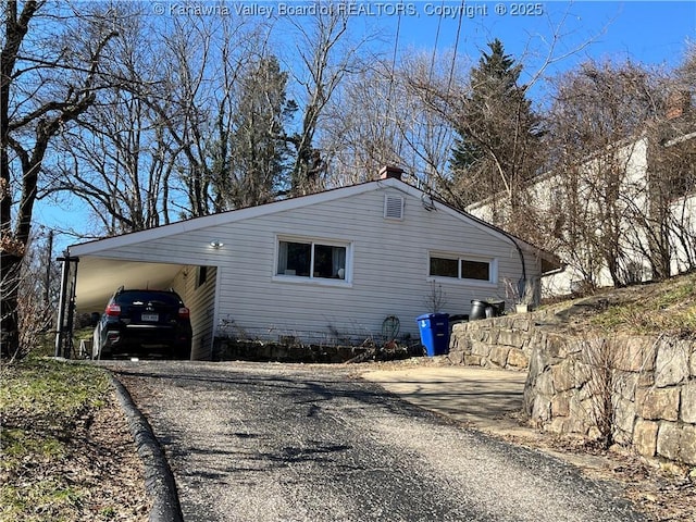 view of side of property with a carport