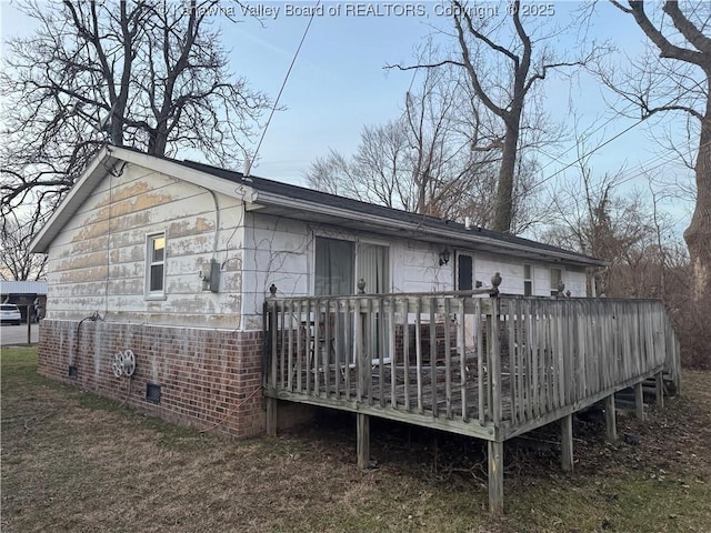 back of property with a wooden deck