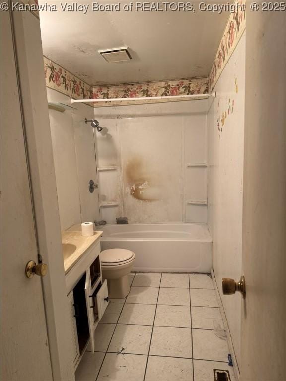 full bathroom featuring tile patterned floors, toilet, bathing tub / shower combination, and vanity