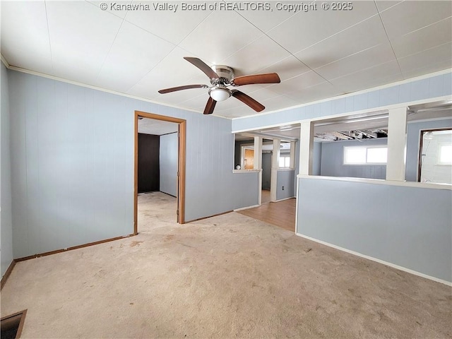 spare room with crown molding, ceiling fan, and light carpet