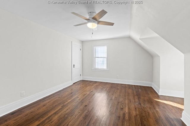 additional living space with lofted ceiling, dark hardwood / wood-style floors, and ceiling fan