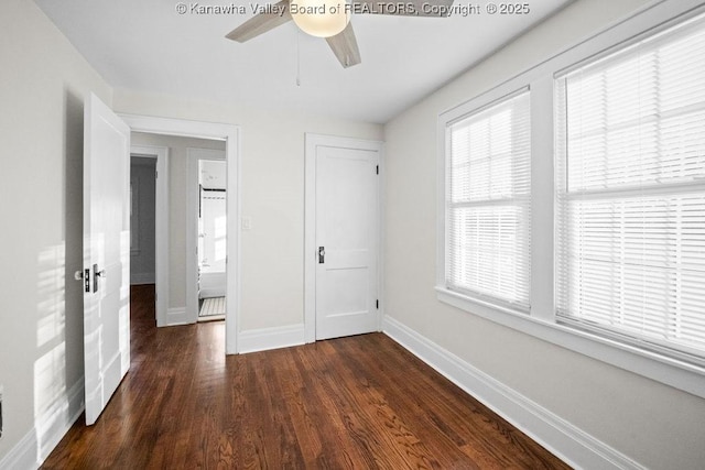 unfurnished bedroom with ceiling fan, dark hardwood / wood-style flooring, and a closet