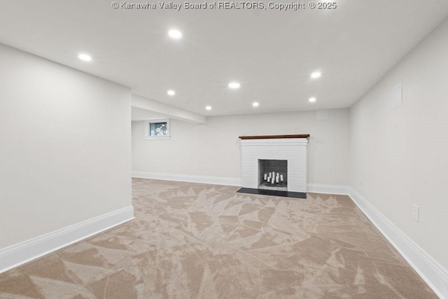 basement featuring light carpet and a fireplace