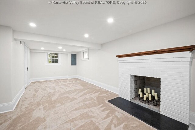 basement with light colored carpet and a fireplace