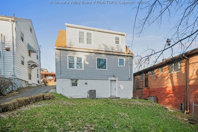 back of house with a yard and cooling unit