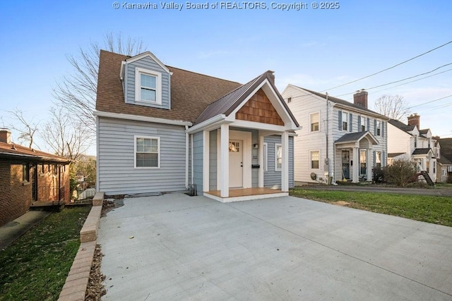 view of front of property featuring roof with shingles